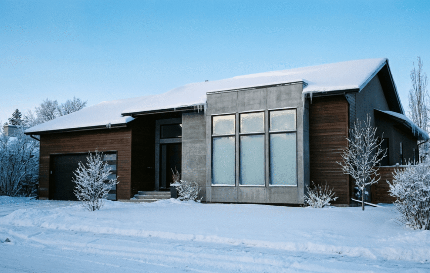 Custom home exterior in Edmonton Alberta during winter with snow on the roof