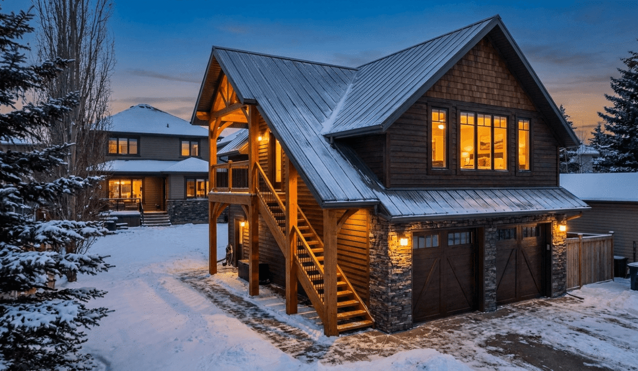 Detached garage with finished suite above it at dusk in Edmonton residential backyard