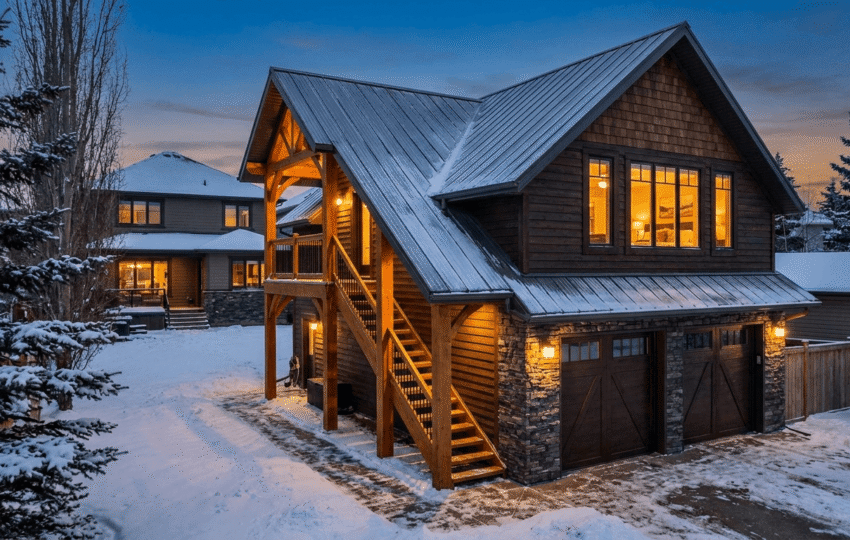 Detached garage with finished suite above it at dusk in Edmonton residential backyard
